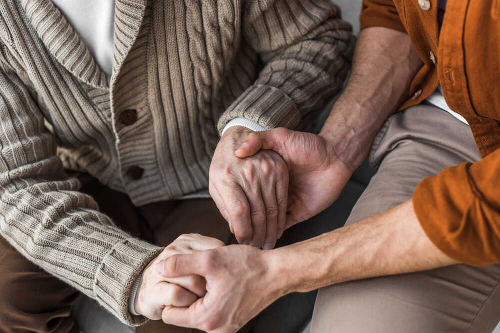 Hands held in support — compassion at the heart of care fees planning