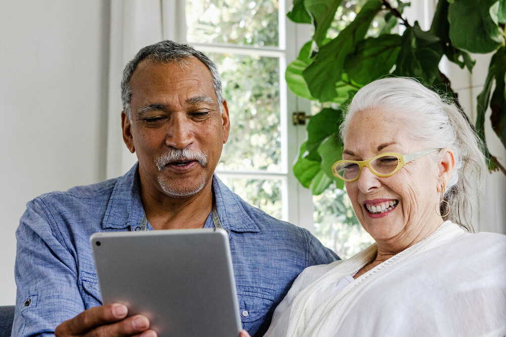 Couple reading articles about inheritance tax and estate planning on a tablet
