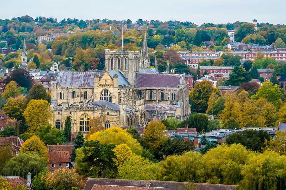 Winchester Cathedral surrounded by autumn trees